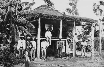 South Sea Islanders standing in front of a house in Mackay in 1907