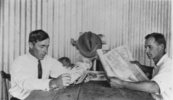 Cane farmers reading newspapers Tully ca. 1929
